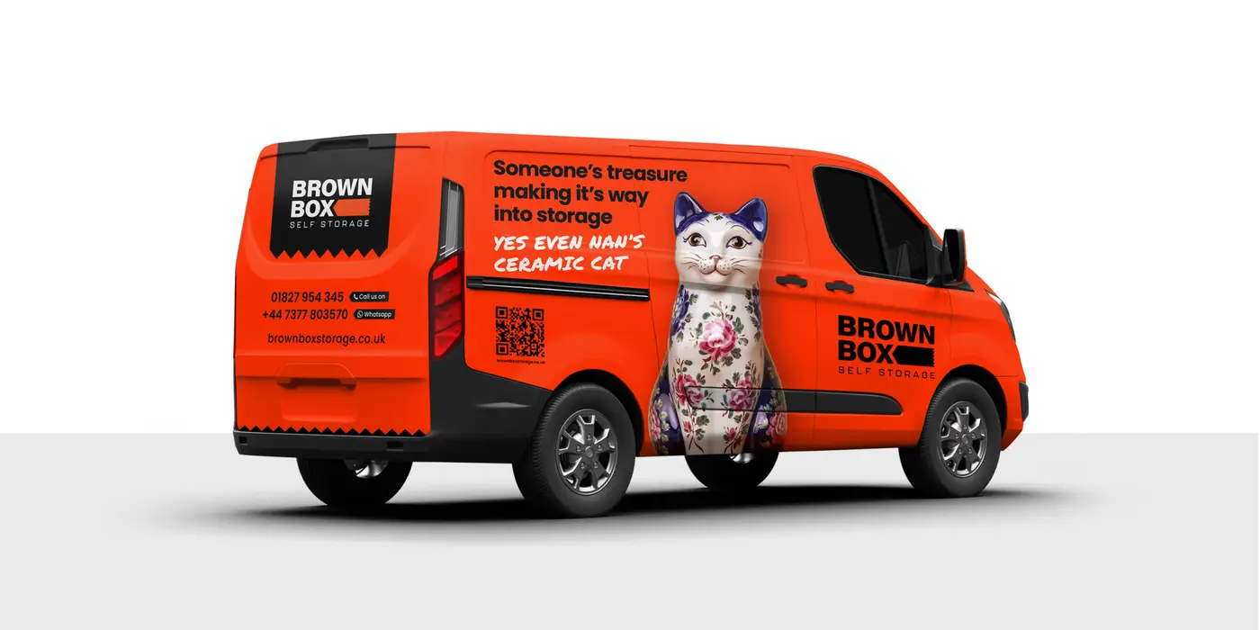 Vehicle ford transit custom vehicle displaying brown box storage brand and graphics wrapped around it.