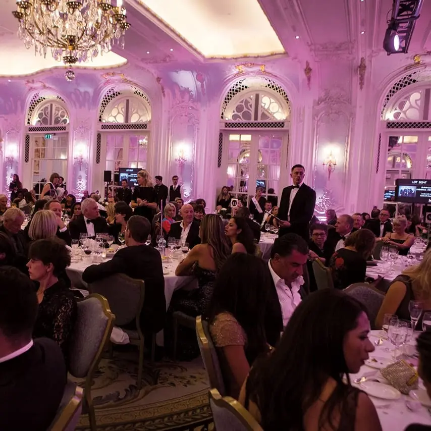 A photo of people seated and dining at the Dorchester hotel London during the charity gala