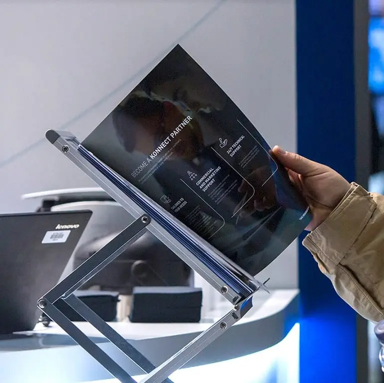 A close-up image of a passer-by viewing the branded event brochure design